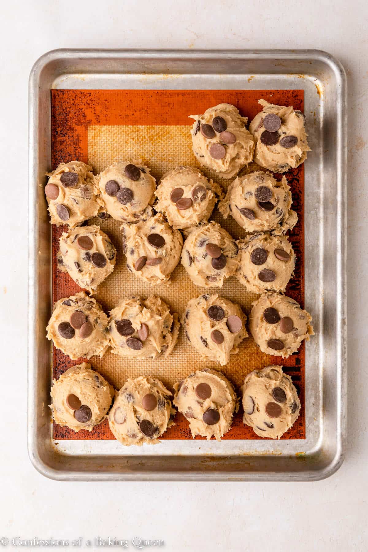 cream cheese chocolate chip cookie dough balls on a silpat lined baking sheet