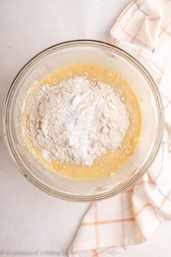 Adding oat flour to banana bread batter.