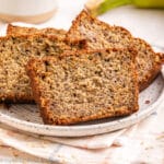 Slices of oat flour banana bread on a plate.
