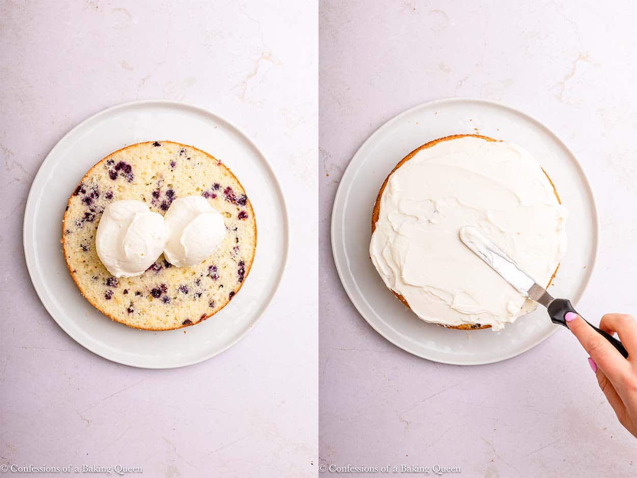 whipped cream cream cheese frosting added to lemon blueberry cake layers on a white plate on a light surface