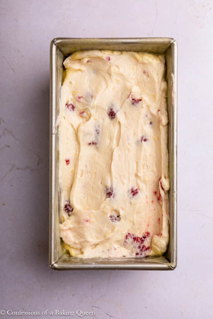 Raspberry lemon batter in a loaf pan ready to be baked.