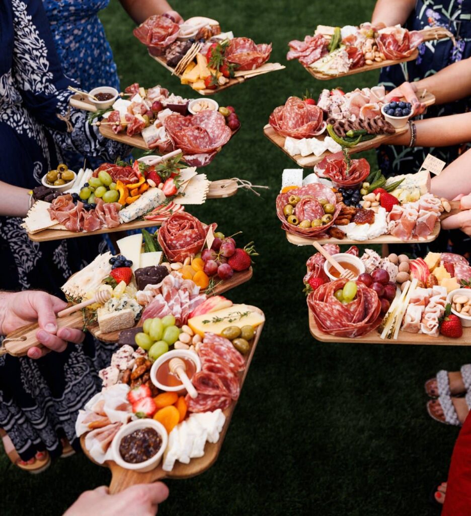 food bloggers holding individual charcuterie boards