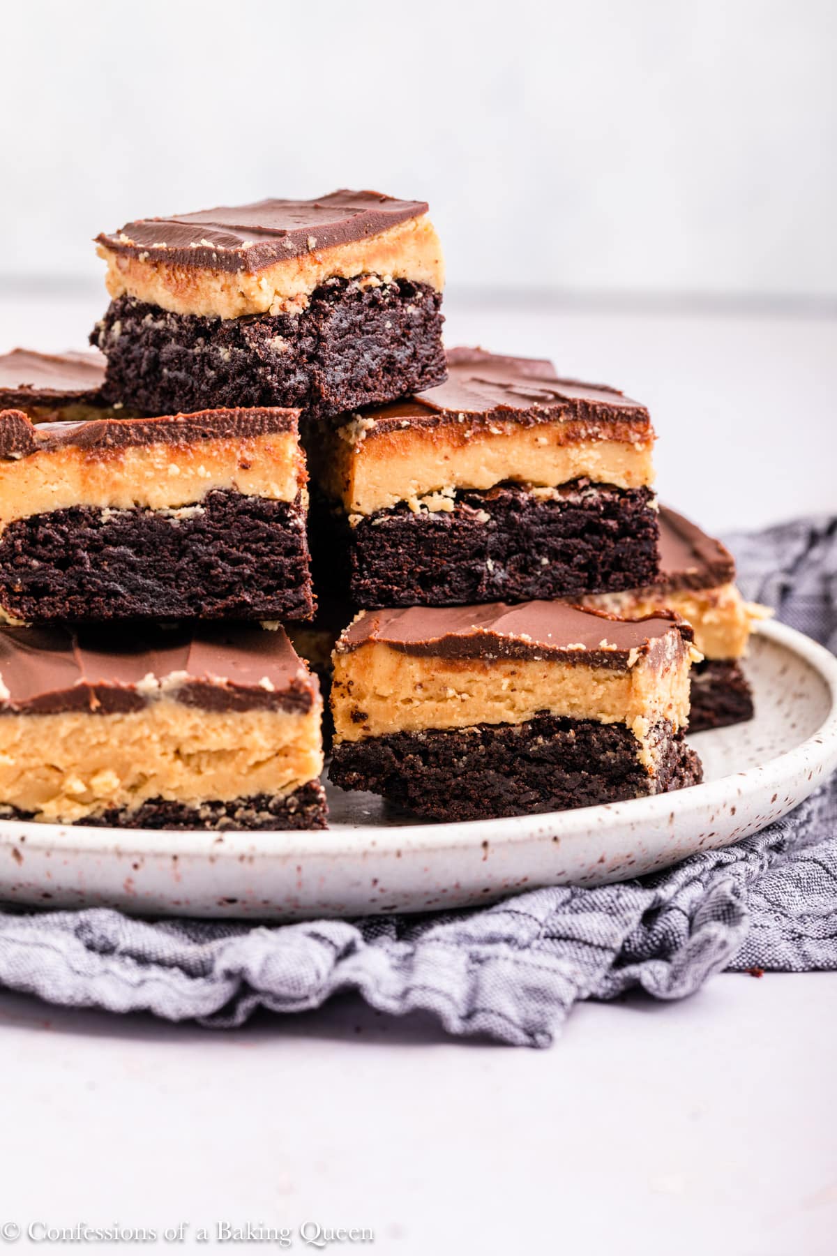 A stack of buckeye brownies on a plate.