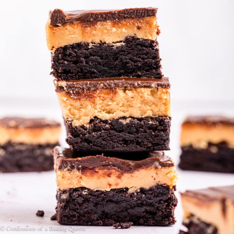 A stack of three buckeye brownies surrounded by other buckeye brownies.