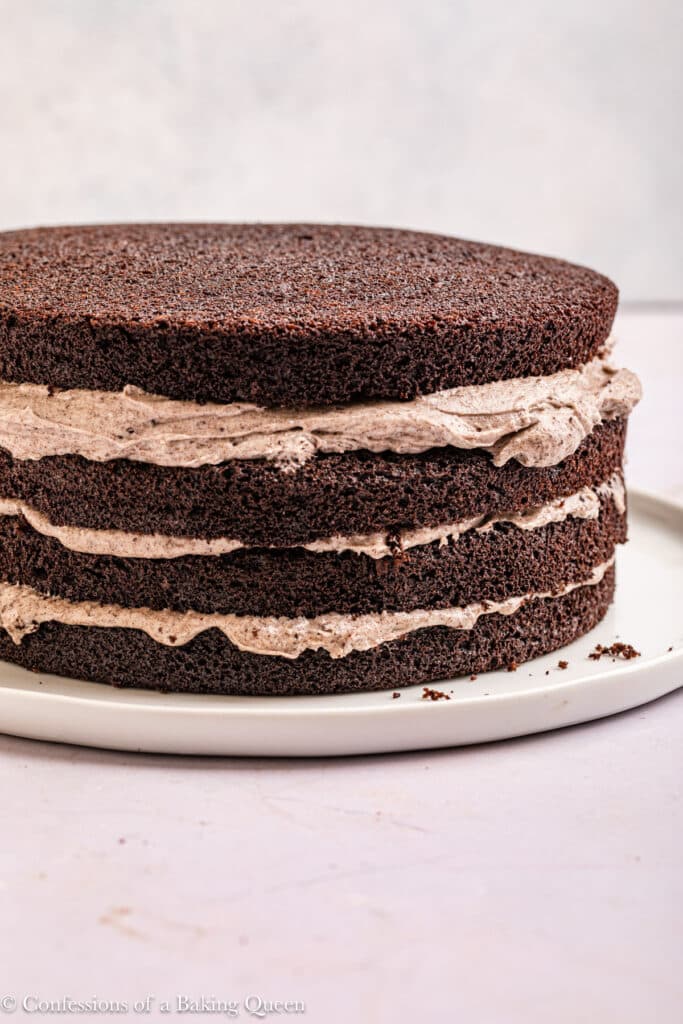 Stacking and filling Oreo layer cake.