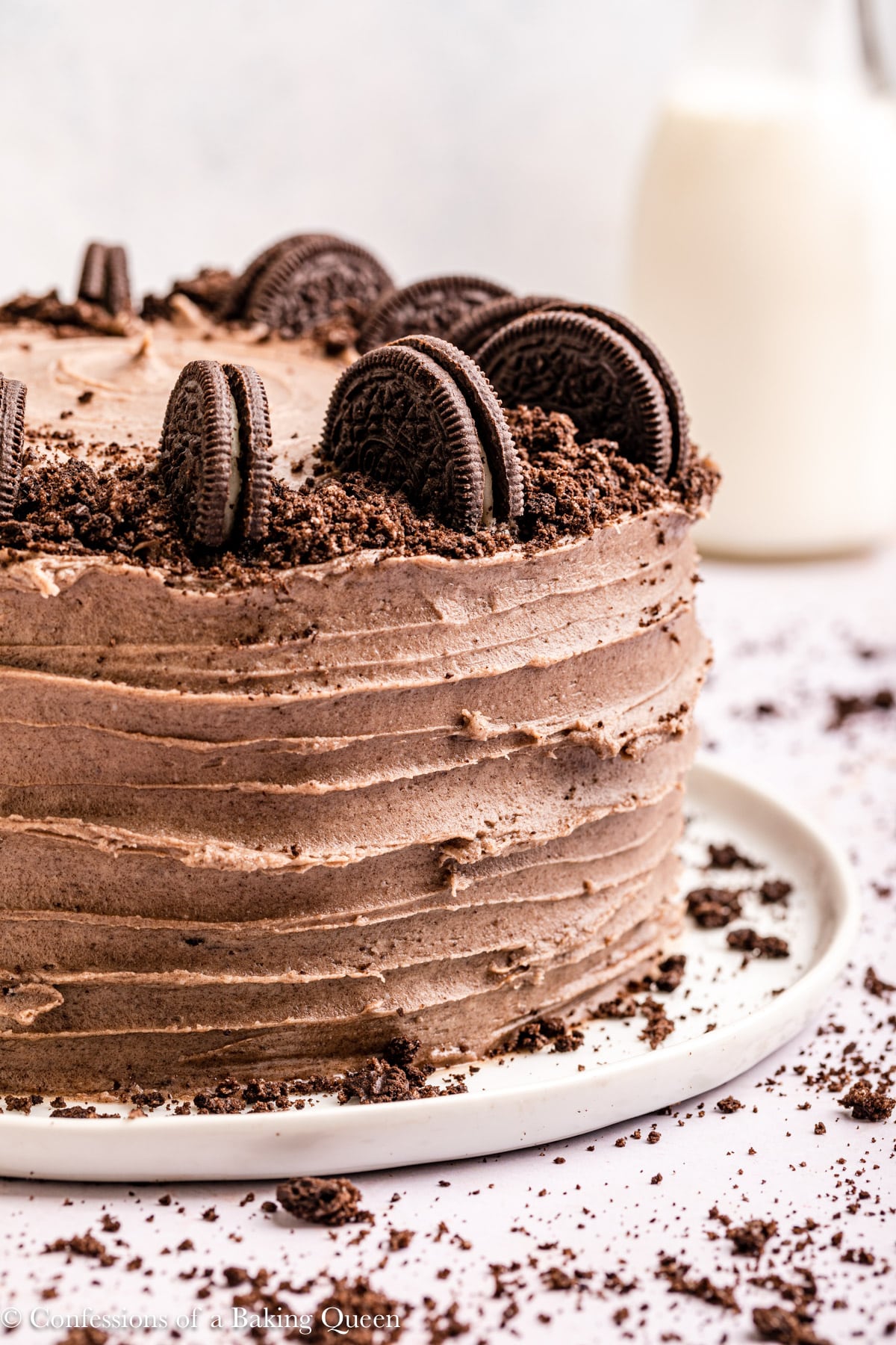 Oreo layer cake on a serving plate.