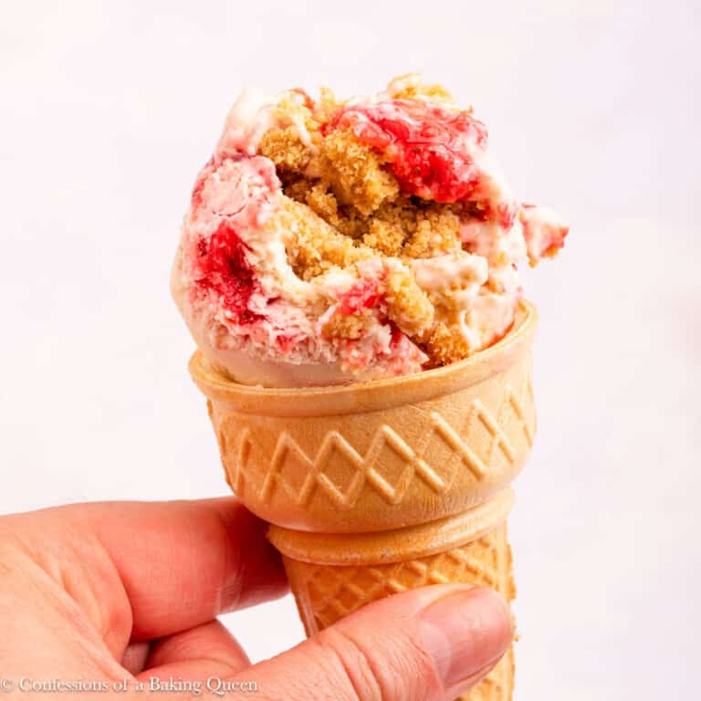 close up of strawberry cheesecake ice cream cone.
