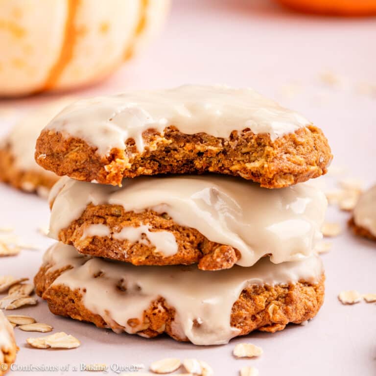oatmeal pumpkin maple cookies stacked on top of each other on a light surface.